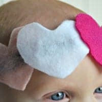 Easy Valentine Headbands for babies. Head band on babys head with three felt hearts two pink one white
