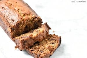 Peanut Butter and Chocolate Chip Banana Bread. Loaf of bread half cut slices.