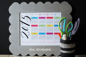 RH-2015 At a Glance Calendar-print on chalk board with gray boarder, Mason jar full of pens and a pair of scissors off to the side of calender
