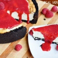Raspberry Cheesecake, cheesecake recipe made with oreo cookie crust and drizzled with a raspberry sauce.