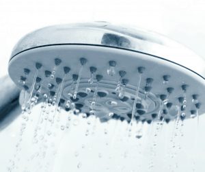 The easy way to get rid of hair clogs in your shower. close up of running shower head