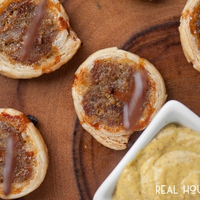 Three Ingredient Sausage Roll Bites. Topped with little football cupcake toppers, served with a side of dijon mustard