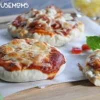 Bread maker pizza dough. Mini pizza's topped with cheese, tomatoe suace