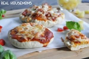 Bread maker pizza dough. Mini pizza's topped with cheese, tomatoe suace