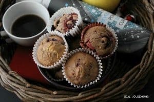Chocolate Berry Muffins. wicker basket filled with hot coffee, apple, magazine, and juice
