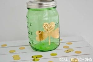 Gold Leaf shamrock Mason Jar .Green Mason jar with gold leaf shamrock on it.