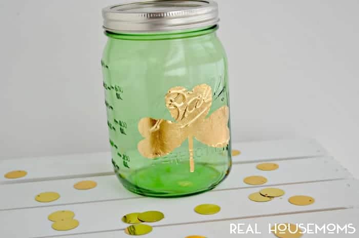Gold Leaf shamrock Mason Jar .Green Mason jar with gold leaf shamrock on it.