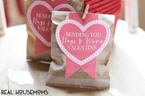 Hugs and Kisses Valentines day gift bag. Small paper bag with heart printable cut out that reads "sending you hugs & kisses valentine"