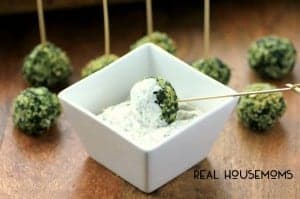 Spinach Balls with panko crumbs served with a side of lemon dip. Toothpicks at the top of the spinach balls for easy grabbing