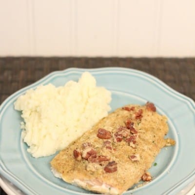 baked pecan and mustard salmon served on a blue plate