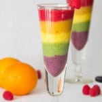 Rainbow Smoothie. Tropical strawberry smoothie, garnished with raseberries. served in a flute glass