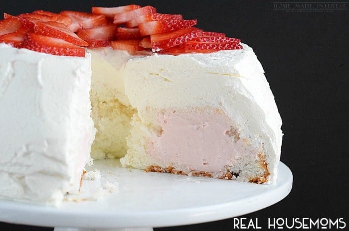 This light and fluffy angel food cake is filled with delicious strawberry cream and frosted with homemade whipped cream. A light and refreshing cake recipe for summer. 