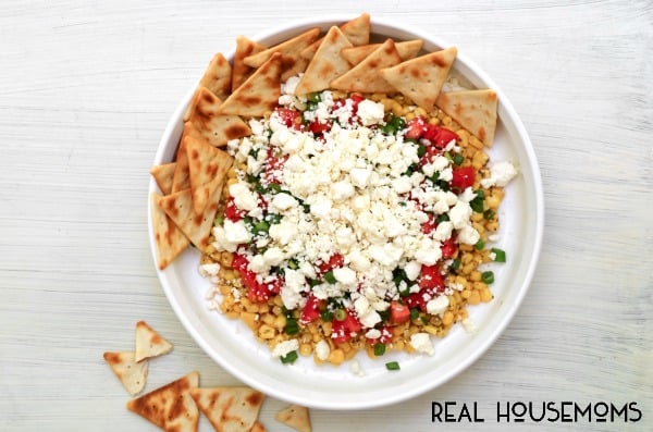 Greek Corn Dip is a Mediterranean inspired cold dip that features sweet corn, feta cheese, and a bold Greek dressing!