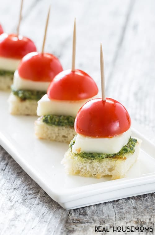 Caprese with Pesto Bites ConCaprese with Pesto Bites will be your go to appetizer this summer with homemade pesto that comes together in a snap!tent1