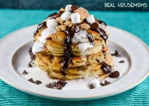S'Mores Chocolate Chip Pancakes with chocolate ganache and marshmallow syrup are a fun, decadent breakfast that the whole family will love!