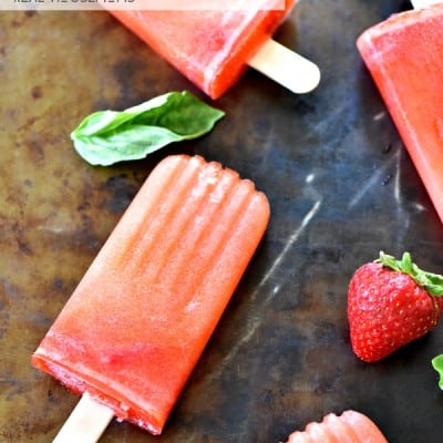 Boozy Strawberry Basil Lemonade Popsicles are crazy awesome out of this world good!!! I love to let them melt in my summer cocktails too!