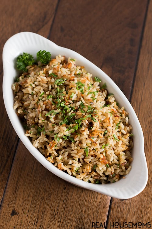 Brown rice gets a makeover with garlic and fresh herbs then baked until perfectly fluffy - this baked brown rice will be your new side dish staple!