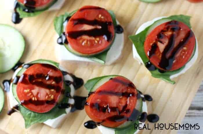 Fresh mozzarella, hand torn basil leaves, crisp cucumbers, a slice of campari tomato, and balsamic glaze make for easy and fresh Garden Caprese Stacks!