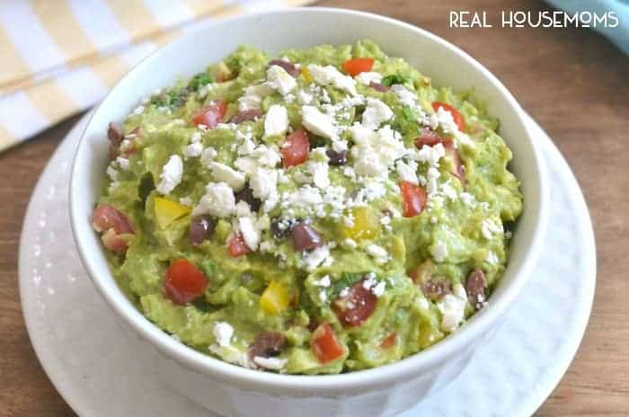 Mediterranean Guacamole combines some of my favorite flavors into one delicious dip! It's a fun twist on the original, and perfect for summer entertaining!!
