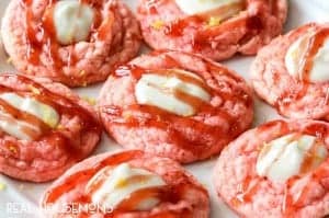 Easy Strawberry Lemonade Cheesecake Cookies are melt in your mouth, sweet strawberry cake deliciousness perfectly complimented by creamy tangy lemonade cheesecake filling. They're the perfect summer cookie!