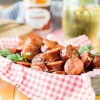 Sweet and Spicy Slow Cooker Kielbasa Bites are the perfect crowd pleasing snack for your next tailgate!