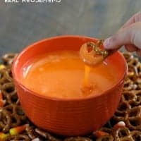 Serve this sweet Slow Cooker Candy Corn Fondue with salty pretzels for a fun Halloween treat!