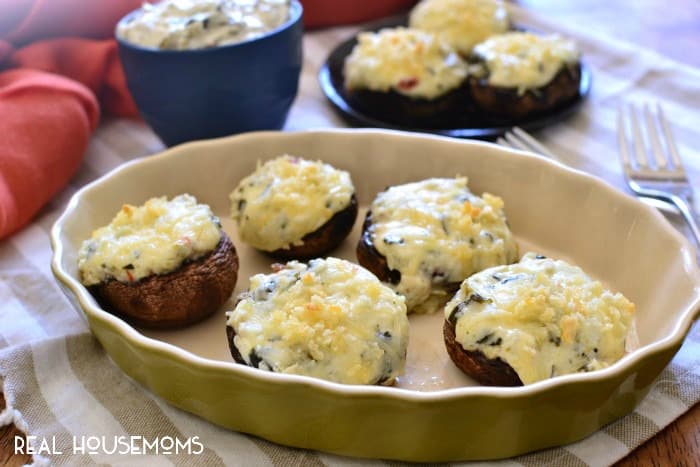 Spinach Dip Stuffed Mushrooms combine two classic flavors into one delicious appetizer! This simple, bite-sized recipe is perfect for holiday entertaining!