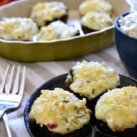 Spinach Dip Stuffed Mushrooms combine two classic flavors into one delicious appetizer! This simple, bite-sized recipe is perfect for holiday entertaining!