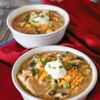 Shredded chicken, black beans, salsa verde & more come together in this simple & easy crockpot BLACK BEAN & CHICKEN SOUP. Perfect for chilly winter days!