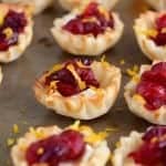 These CRANBERRY BRIE CUPS are just about as easy an appetizer as you can get, and they are so beautiful and delicious!