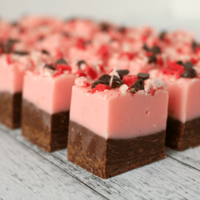 Perfect for your Christmas cookie and candy trays, this delicious Peppermint Crunch Fudge is a must-have this holiday season! Topped with mini-chocolate chips and peppermint crunch, this double layer fudge is easy to make and super-delicious!