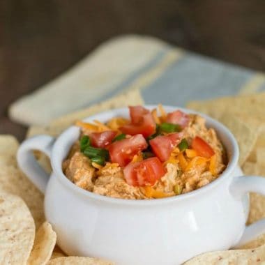 This fun recipe for SLOW COOKER CHICKEN TACO DIP is great to serve at your next party or game day!