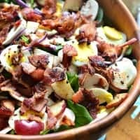 SPINACH SALAD WITH WARM MAPLE BACON DRESSING is the ultimate twist on a classic! It's loaded with delicious flavor and perfect for lunch, dinner, or your next get together!