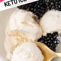 close up bite of keto ice cream on a spoon resting in the bowl with ice cream and fresh blackberries with the title of the post on top of the image