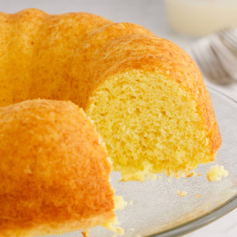 square image of weight watchers lemon cake with a slice removed to show the inside