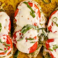 square image of baked carese chicken topped with basil