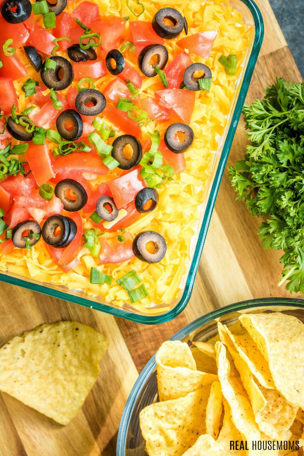 looking down at pan of 7 layer dip with chips alongside