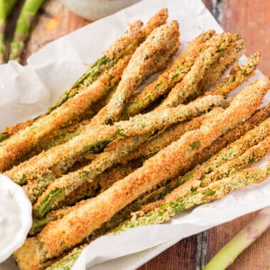 square image of air fryer asparagus fries in a bakset