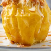 air fryer baked apple with vanilla ice cream on top with recipe name at the bottom