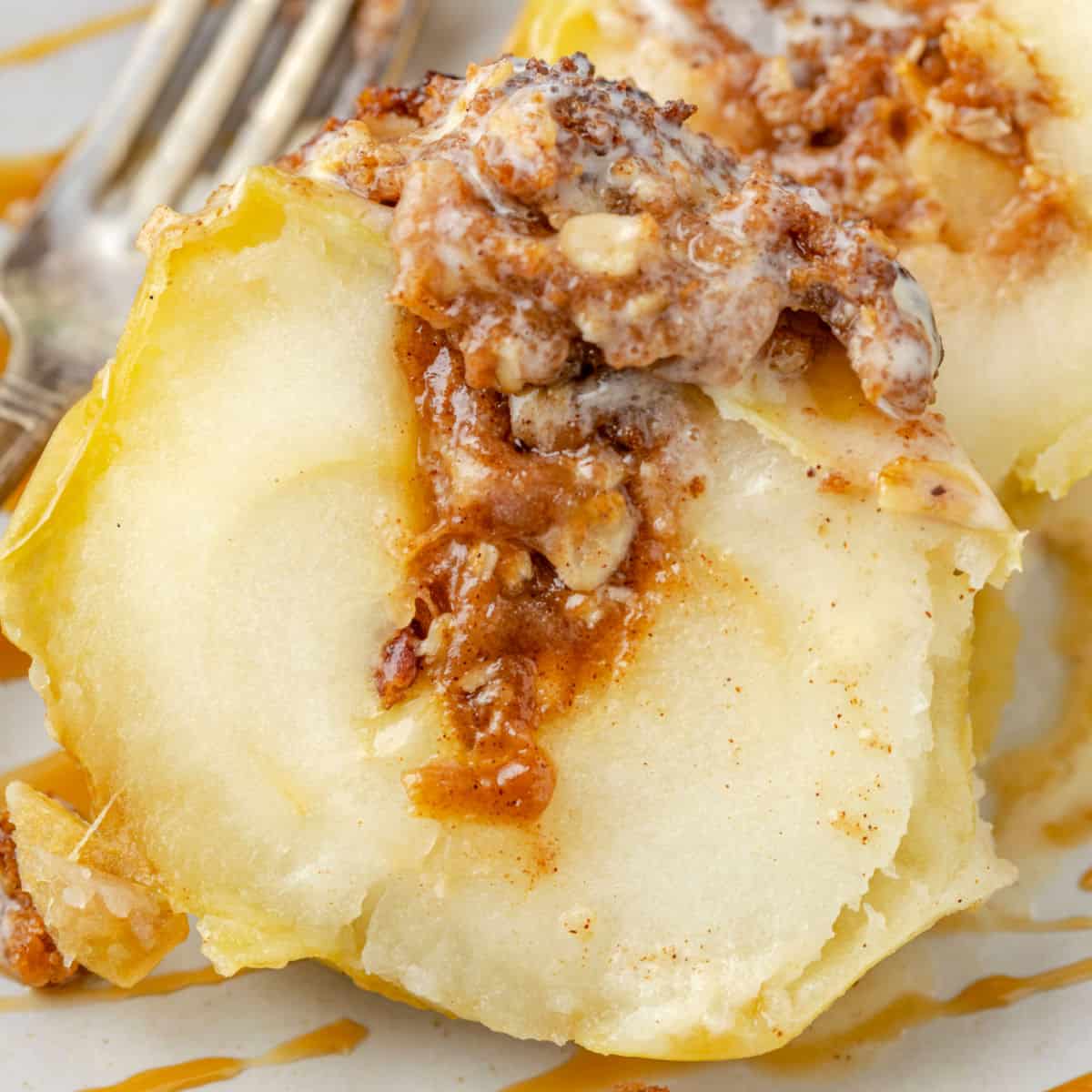 square image of air fryer baked apple cut open to show filling inside