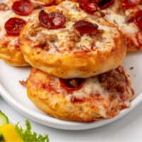 angled view of air fryer biscuit pizzas on a plate with recipe name at the bottom