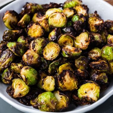 square image of air fryer brussel sprouts in a serving bowl