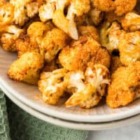 air fryer cauliflower in a serving bowl with recipe name at the bottom