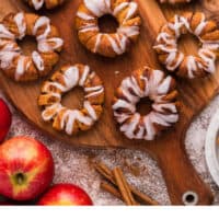air fryer cinnamon roll wrapped apple rings on a wooden serving board with recipe name at the bottom