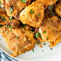 loking down at air fryer fried chicken piled on a plate with recipe name at the bottom