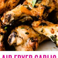 air fryer garlic parmesan chicken wings piled on a plate with recipe name at bottom