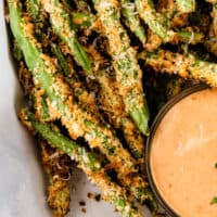 air fryer green bean fries in a basket with recipe name at the bottom