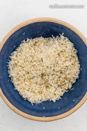 shredded parmesan and seasonings mixed with seasoned panko breadcrumbs in a bowl