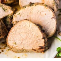 close up of air fryer pork loin slices on a platter with recipe name at the bottom