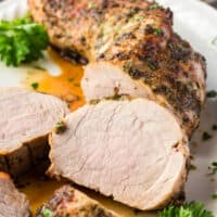 square image of air fryer pork loin with some slices cut from the loin